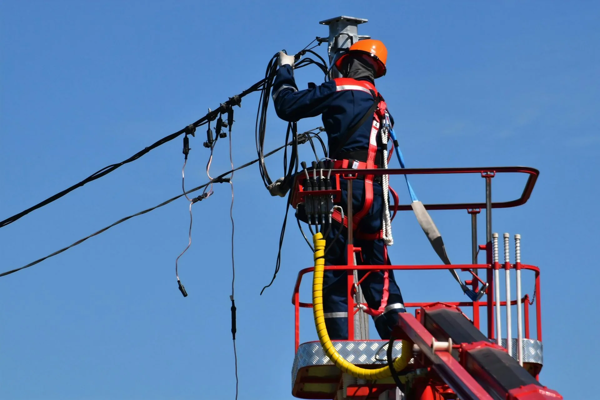 Lineman working on overhead power lines